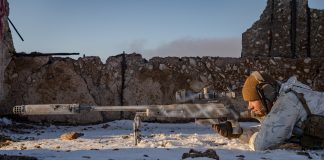 bolt action rifle in a snowy environment