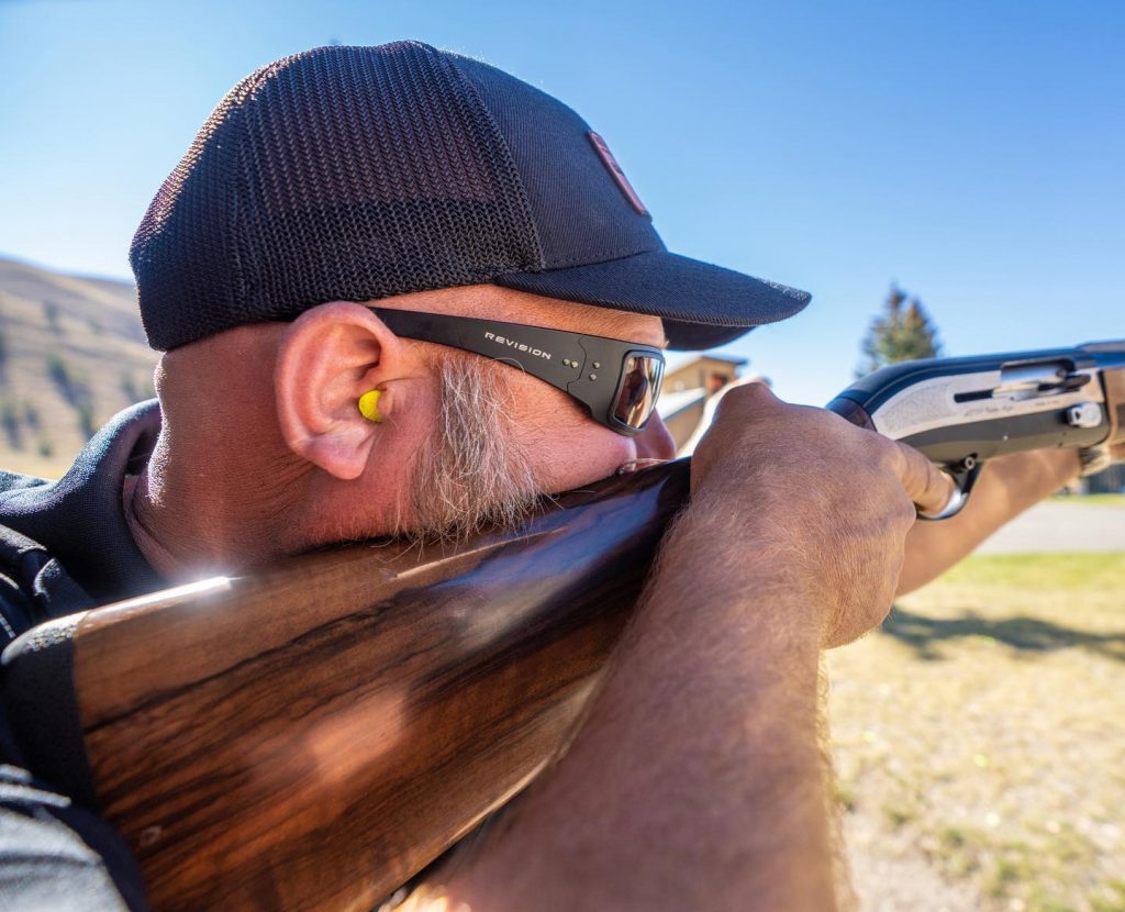 Man holding a rifle and wearing Speed Demon glasses