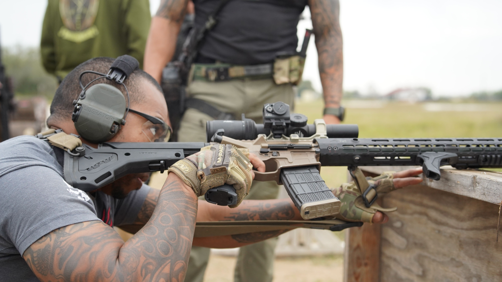 carbine with LPVO being shot off a barricade
