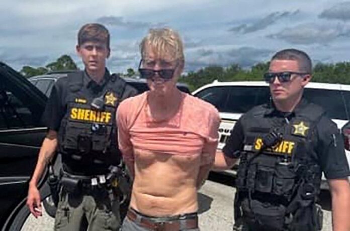 Suspected Trump golf course gunman Ryan W. Routh stands handcuffed after his arrest during a traffic stop near Palm City